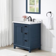 a bathroom vanity with two sinks and a mirror on the wall next to a window