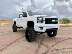 a white truck parked on top of a parking lot