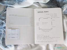 an open notebook on top of a sheet of paper