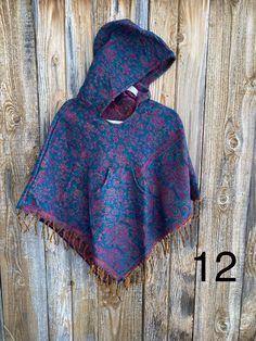 Our hooded big kid ponchos are made of soft acrylic wool with colors hand selected from our world travels. XXLarge fits about 10 years up to Women's size XS. Approx up to 5' tall. Thank you very much for supporting our small shop. Blue Hooded Winter Cape, Traditional Hooded Winter Poncho, Hooded Winter Poncho One Size, Winter Hooded Poncho One Size, Traditional One Size Hooded Poncho, Hooded Fall Festival Poncho, Blue Winter Festival Poncho, Multicolor Winter Poncho For Outdoor Activities, Multicolor Winter Poncho For Outdoor