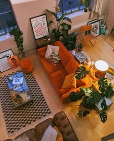 an overhead view of a living room with orange couches