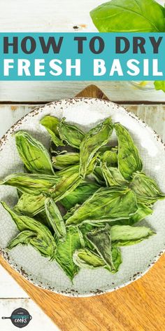 fresh basil leaves in a bowl on a wooden table with the title how to dry fresh basil