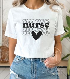 Boho Nurse Heart Shirt, TShirt for Registered Nurse, RN Nurse T-shirt, Gift For Nurse, Nurse Graphic Shirt, Nursing School, Nurse Life Shirt Bella Canvas 3001T:  T-Shirt Sizing Please reference the size chart before selecting shirt size.  Use one of your own t-shirts to measure the size and fit.  Then compare with the size chart provided to ensure an accurate fit. T-Shirt Materials 100% combed and ring-spun cotton. Heather colors are 90% combed and ring-spun cotton, 10% polyester. Pre-shrunk fab White Relaxed Fit T-shirt With Heart Graphic, Short Sleeve Graphic Tee With Heart Graphic, Heart Graphic Short Sleeve Graphic Tee, Basic White T-shirt With Heart Graphic, Short Sleeve Tops With Heart Graphic, White Cotton Nursing T-shirt, Relaxed Fit Crew Neck Shirt With Heart Graphic, Basic White Print Short Sleeve Tops, White Print Short Sleeve Basic Tops