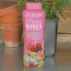 a bottle of jackson and perkinss rose deodorant next to a potted plant