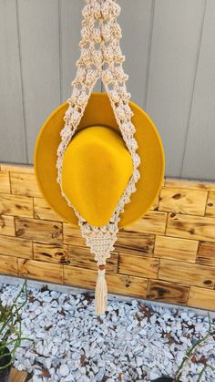 a yellow hat is hanging from a hook