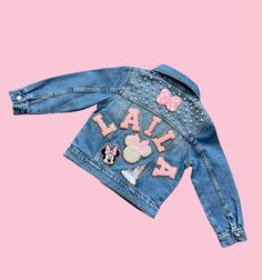 a denim jacket with minnie mouse patches on it