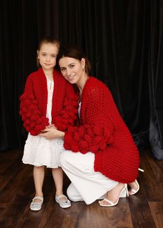 "Keep your little one warm and comfortable with our wonderful knitted sweater. A warm and soft coat is perfect for both stylish minimalist dresses and your child's everyday wear. The sweater has a loose fit, which makes it very comfortable for your child. The shoulder line is displaced. Delicate knitted cardigan made of quality yarn with the addition of 50 % wool, 50% acrylic. The cardigan is very practical. In the photo color - red . Adult Sweater measurements (measurements taken in a horizonta Red Knitted Sweater Coat For Winter, Red Knit Long Sleeve Cardigan, Red Long Sleeve Knit Cardigan, Cozy Red Knitted Outerwear, Red Chunky Knit Winter Cardigan, Red Knitted Cardigan For Winter, Red Knitted Winter Cardigan, Oversized Red Knitted Cardigan, Cozy Red Soft Knit Outerwear