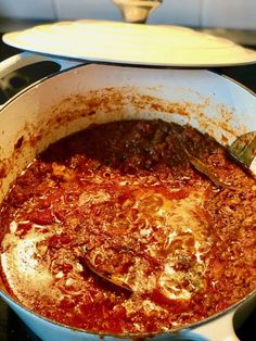 a large pot filled with food sitting on top of a stove