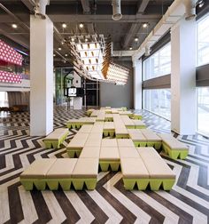 an empty room with tables and chairs in the middle is decorated with checkered flooring