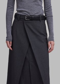 Color: Charcoal Heavyweight woven fabric Relaxed fit Midi length Double layered at front High front slit Asymmetrical hemline Back illusion welt pocket Belt loops Side seam zip closure Hook and bar closure 63% Polyester 27% Rayon 10% Wool Dry Clean By The Frankie Shop. Imported A Line Midi Skirt Outfit, Classic Fashion Looks, Ralph Lauren Looks, Ropa Upcycling, Trendy Mom Outfits, Long Wrap Skirt, Midi Wrap Skirt, Diy Clothes And Shoes, The Frankie Shop