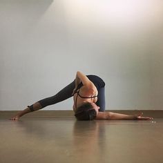 a woman is doing yoga on the floor