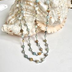 This necklace is the perfect way to bring summer serenity to any look. The amazonite beads evoke the natural beauty of a sandy beach and the peaceful rolling of the ocean. Let its calming energy help you find balance and harmony wherever you go. Beautifully wrapped with oxidized silver wire. It can be worn as wrap bracelet as well. Length 33.5" Known as the “hope” stone, the Amazonite is an excellent manifestation tool. Embracing the fluid energy of water, this stone guides you to overcome setba Single Strand Amazonite Spiritual Beaded Necklace, Amazonite Gemstone Beads Necklace For Meditation, Amazonite Necklace With 108 Round Beads, Bohemian Amazonite Single Strand Beaded Necklace, Amazonite Crystal Necklace With Round Beads, Amazonite Crystal Necklace With Round Natural Stones, Bohemian Amazonite Single Strand Jewelry, Bohemian Single Strand Amazonite Jewelry, Balance And Harmony