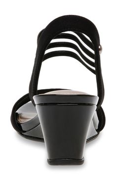 An ankle strap adds sporty style to this open-toe wedge sandal that is perfect for a day in the sun. 58mm heel Open toe Striped strap detail Slip-on Wedge heel Textile and synthetic upper/synthetic lining and sole Imported Black Low Heel Wedge Sandals For Summer, Black Low Heel Wedge Sandals, Black Slingback Sandals With 4-inch Heel For Summer, Wedge Sandals With Cushioned Footbed And Ankle Strap, Black Wedge Heel Slingback Sandals With Heel Loop, Black Wedge Sandals With Arch Support And Ankle Strap, Black Open Toe Wedge Sandals With Arch Support, Black Open Heel Sandals With Arch Support, Black Open Heel Shoes With Arch Support