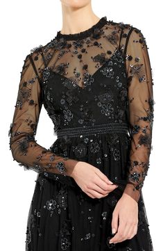 Sparkling blooms alight on dreamy illusion lace in this enchanting party dress cut to a leg-baring length. 34 1/2" length Jewel neck Long sleeves Partially lined 100% polyester Spot clean Imported Asian Owned/Founded Evening Lace Dress With Sheer Tulle Bodice, Embellished Lace Evening Dress, Evening Lace Dress With Sheer Bodice, Party Lace Dress With Sheer Sleeves, Embellished Lace Evening Dress For Party Season, Floral Embellished Evening Dress For Prom Season, Floral Embellished Evening Dress For Prom And Parties, Spring Evening Lace Dress With Sheer Sleeves, Spring Evening Lace Dress With Sequins