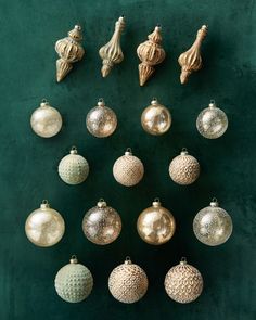 christmas ornaments are arranged on a green surface