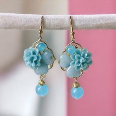 Introducing our stunning Blue Floral 3D Earrings, perfect for adding a touch of ethnic charm to your jewelry collection. Handcrafted with exquisite attention to detail, these earrings feature vibrant blue floral patterns that truly make a statement. These earrings boast a unique three-dimensional effect that adds depth and dimension to your ensemble. The hypoallergenic design ensures comfortable wear for even the most sensitive ears, making them an ideal choice for everyday use. Whether you're attending a special event or simply want to elevate your casual look, these ethnic-style earrings effortlessly complement any outfit. The beautiful blue floral motif captures the essence of traditional craftsmanship, while the modern 3D design brings a contemporary twist. Blue Flower Charm Drop Earrings, Mother's Day Flower Shaped Jewelry With Matching Earrings, Bohemian Light Blue Flower Jewelry, Elegant Light Blue Flower Earrings For Gift, Mother's Day Gift Dangle Flower Earrings, Mother's Day Gift Flower Dangle Earrings, Turquoise Dangle Earrings With Flower Charm, Blue Drop Earrings With Flower Charm, Elegant Blue Drop Earrings With Flower Charm