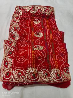 Indian Handmade Cutdana Ans Gardogi With Stone Work Saree, Unique Design Work Saree Item: Handmade Gotta Patti Bandhej Saree Fabric: Georgette Blouse: Handmade Gotta Patti Red Chinon Sharara With Cutdana Detail, Red Chinon Sharara With Cutdana, Traditional Red Pre-draped Saree For Festive Occasions, Red Sharara With Cutdana For Navratri, Red Sharara With Zari Work For Navratri, Red Chinon Salwar Kameez For Transitional Season, Red Georgette Choli With Cutdana, Red Saree Set With Mirror Work, Festive Red Pre-draped Saree With Bandhani Print