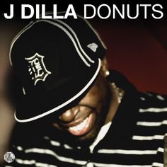 a man wearing a black and white striped hat with the words j dilla donuts on it