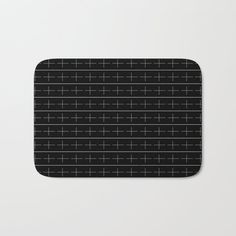 a black and white bath mat with lines on it