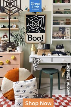 a room filled with lots of furniture and decor on the walls, including a spider web sign