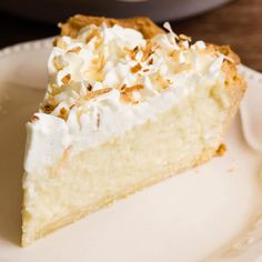 a slice of coconut cream pie on a white plate