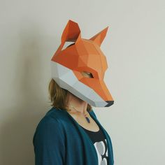 a woman wearing an origami fox mask