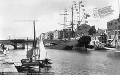 an old black and white photo of boats in the water