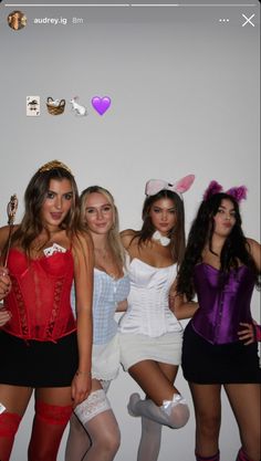 four women dressed up in costumes posing for the camera