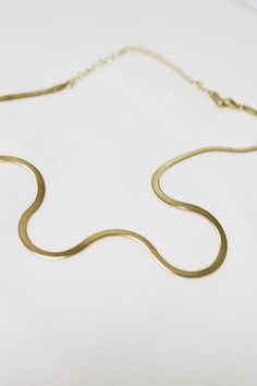 Lola Gold Herringbone Snake Chain Choker Necklace wraps perfectly around the neck and lobster claw closure. This item is currently sold out at the moment, it will take 1-2 weeks to make. Please pre-order now! Don't worry, we will keep you in the loop and message you when it is ready to ship! Thank you! ◊ 18K Gold Plated Over Brass ◊ Short length: 31 cm + 10 cm extension ◊ Long length: 38cm + 10 cm extension ◊ Chain measures 3mm wide ◊ The chain feels very lightweight and easy to wear ◊ Lobster c Everyday Snake Chain Necklace With Lobster Clasp, Herringbone Necklace With Lobster Clasp As Gift, Herringbone Necklace With Lobster Clasp For Gifts, Gold Snake Shape Chain Necklace Gift, Gold Snake Chain Choker As A Gift, Gold Snake Chain Necklace With Lobster Clasp As Gift, Snake Shape Gold Chain Necklace Gift, Gold Snake Chain Choker With Delicate Details, Gold Delicate Snake Chain Choker