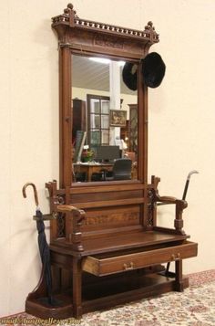 an antique wooden bench with umbrella and mirror