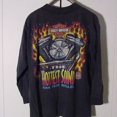 a black harley davidson long sleeve shirt with flames on the front and an image of a motorcycle