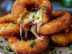 some onion rings are stacked on top of each other with cheese and parmesan