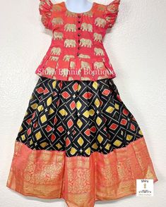 Indian dress for little girl. Ikkat silk lehenga and pure silk choli for kids. Elephant zari. Banaras border. Kids pattu langa choli. Very pretty peachish pink pure silk choli with butta hands and a peep hole tie back. Very pretty elephant motifs in zari. The lehenga is a beautiful multi colors on black with a contrast orange Banaras silk border. The big zari border is in a very elegant design. The lehenga has a black body on top and comes from the shoulder. Lehenga measurements: ----Choli: Leng Stylish Lehenga, Hippie Birthday Party, Pattu Langa, Indian Party, Orange Blouse, Indian Dress, Cute Embroidery, Silk Lehenga, Black Body