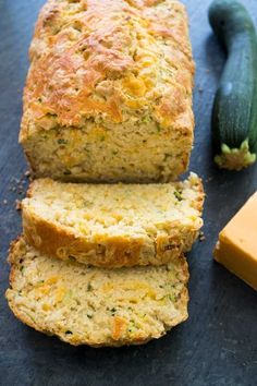 slices of zucchini bread on a table next to butter and a cucumber