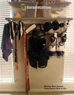 there is a rack with hockey gear and skis on it