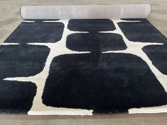 a black and white rug on the ground