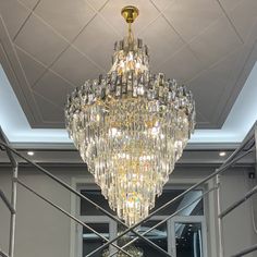 a large crystal chandelier hanging from the ceiling in a room with white walls