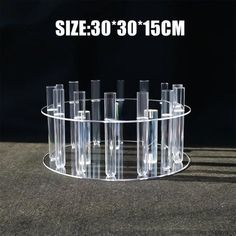 a display case with eight clear tubes in it on a table next to a black background