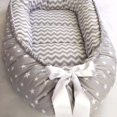 a gray and white dog bed with stars on it