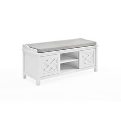 a white tv stand with a gray cushion on it's top and bottom shelf