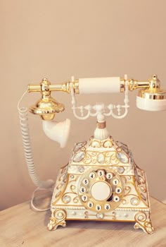 an old fashioned phone sitting on top of a wooden table