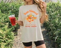 Crafted with love and a nod to retro aesthetics, this shirt is a delightful addition to your wardrobe. Its whimsical design features ripe oranges basking in the sun, evoking a sense of warmth and nostalgia. Perfect for those who adore all things cute and timeless! Whether you're strolling through a farmer's market or simply lounging with friends, this tee promises to brighten your day with its cheerful motif and soft, breathable fabric. Pair it effortlessly with your favorite jeans or a flowy skirt for a look that's effortlessly chic. Bring a slice of sunshine wherever you go with our "Sun Kissed Oranges" shirt -- because life's too short not to be sweet and stylish! Add it to your cart today and let the citrusy charm elevate your everyday adventures. 🧡 The soft-washed, garment-dyed fabri Retro Orange T-shirt For Spring, Retro Funny Print Shirt For Spring, Orange Cotton Top With Retro Print, Retro Shirt With Funny Print For Spring, Spring Retro Pre-shrunk Shirt, Retro Relaxed Fit Pre-shrunk Shirt, Spring Cotton T-shirt With Retro Print, Cotton T-shirt With Retro Print, Relaxed Fit, Cotton T-shirt With Retro Print And Relaxed Fit