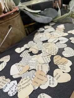 a table topped with lots of paper hearts