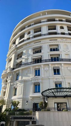 a large white building with many windows and balconies