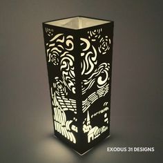 an intricately designed vase is lit up on the table