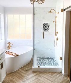 a bathroom with a tub, shower and sink