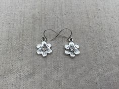 "These are simple, chic and pretty little flower earrings. They are shiny and bright. Versatile and classic. The perfect everyday earrings for any nature lover. The earrings measure 5/8\" long by 5/8\" wide and are made from plated silver. They hang from simple silver ear wire hooks. Overall drop length is 3/4\". I have a matching necklace in my shop if you would like the whole set. Here is a direct link Thanks for stopping by! Please take a moment and visit the rest of my Etsy store. I have man Boho Hoop Earrings, Botanical Earrings, Silver Flower Earrings, Hammered Hoop Earrings, Bee Jewelry, Bee Earrings, Earring Tree, Jewelry Tree, Unique Jewelry Designs