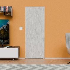 a flat screen tv sitting on top of a wooden stand in a living room next to a book shelf