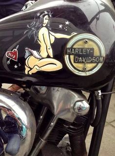 a close up of a motorcycle with a woman on the front and back tire cover