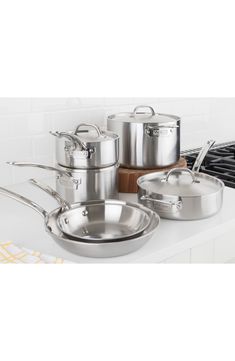 stainless steel pots and pans on a kitchen counter